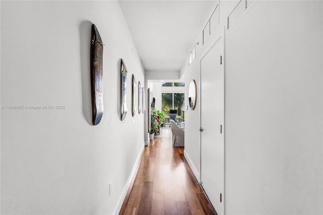 hallway with dark hardwood / wood-style flooring