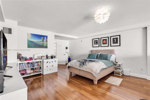 bedroom with hardwood / wood-style floors