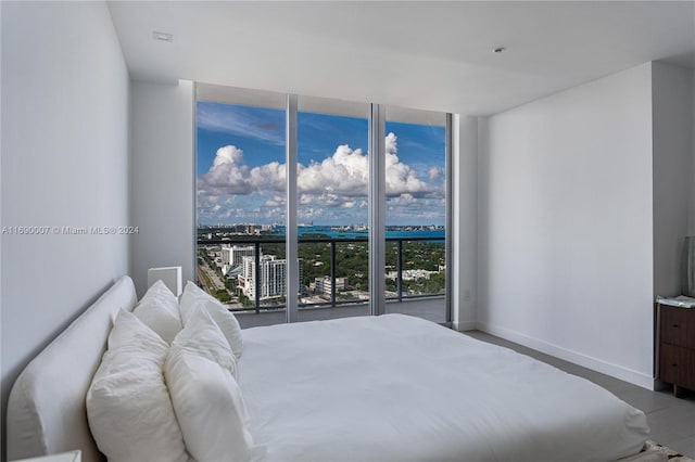 bedroom featuring access to exterior and floor to ceiling windows