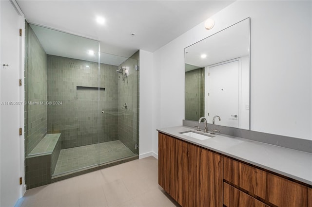 bathroom with vanity and a shower with shower door