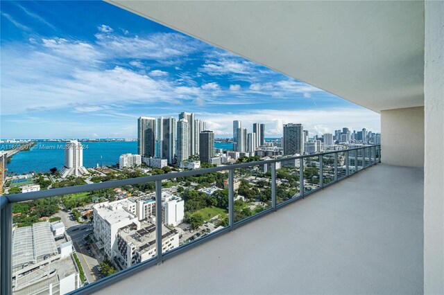 balcony featuring a water view