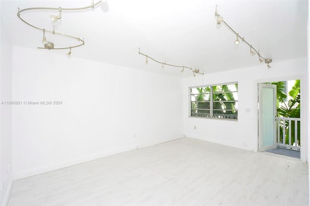 spare room with light hardwood / wood-style flooring