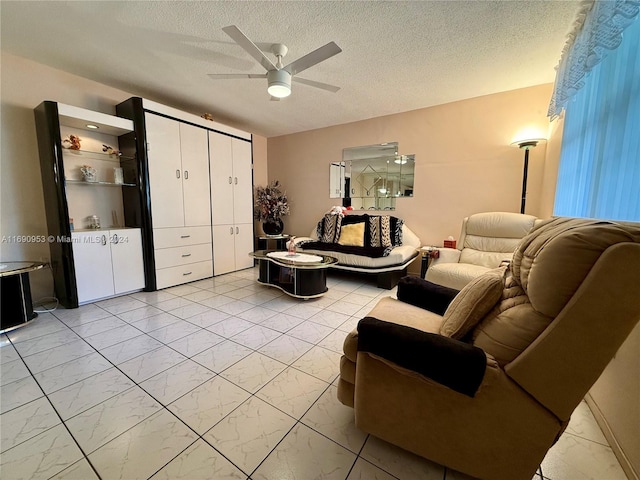 living room with a textured ceiling and ceiling fan