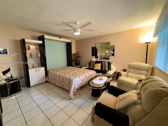 tiled bedroom with a textured ceiling and ceiling fan