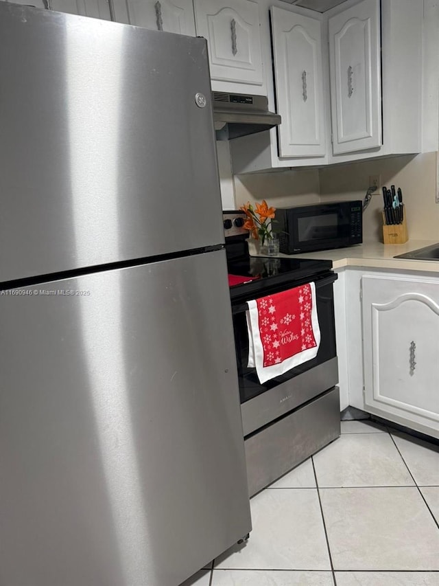 kitchen with white cabinetry, appliances with stainless steel finishes, and light tile patterned floors