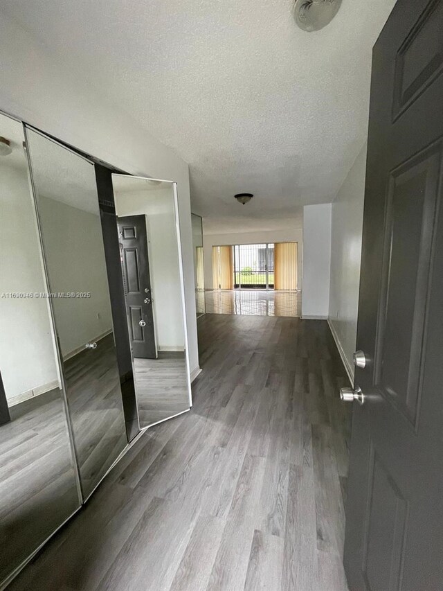 kitchen featuring a paneled ceiling, stove, sink, white cabinetry, and stainless steel refrigerator