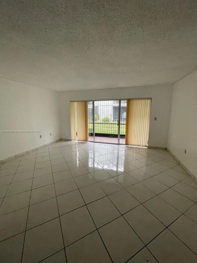 kitchen featuring sink, appliances with stainless steel finishes, light tile patterned flooring, white cabinetry, and extractor fan