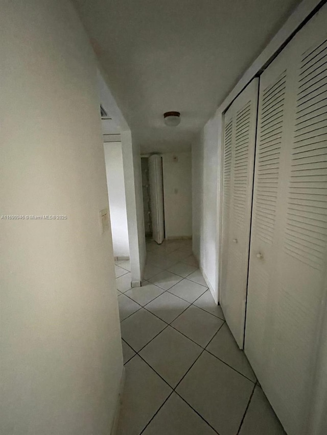 corridor with light tile patterned flooring