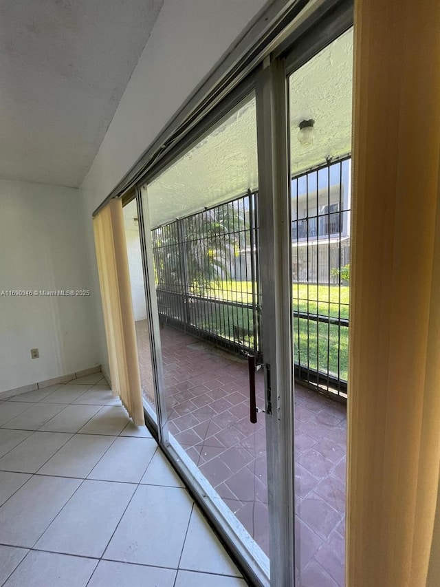 entryway with a healthy amount of sunlight and tile patterned floors