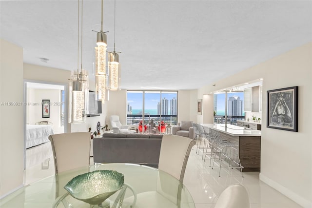 dining space with a textured ceiling and light tile patterned floors