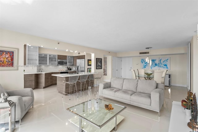 living room with light tile patterned floors and sink