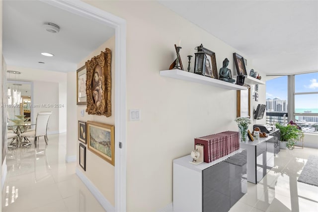 hallway with expansive windows and light tile patterned floors