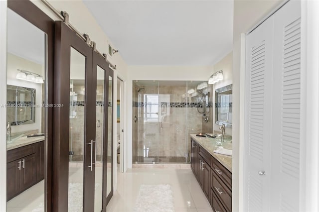 bathroom with vanity, tile patterned floors, and a shower with shower door