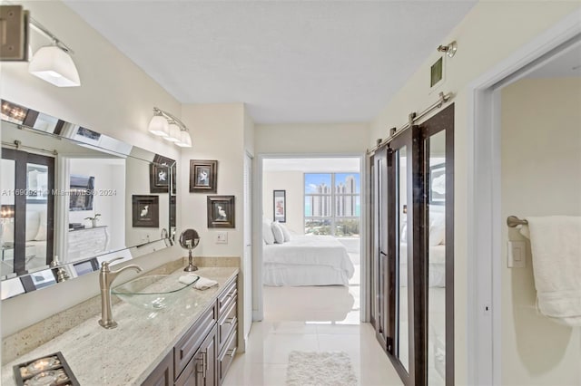 bathroom featuring tile patterned flooring and vanity