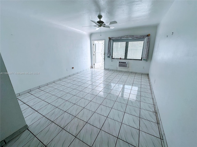 spare room featuring ceiling fan, light tile patterned floors, and a wall mounted AC