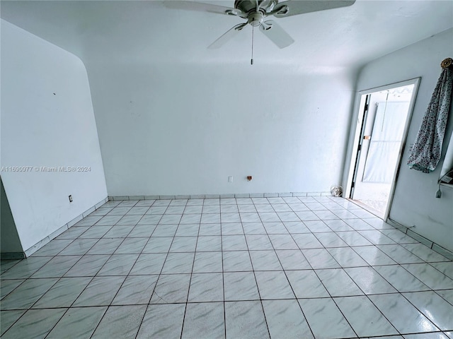 unfurnished room featuring ceiling fan and light tile patterned floors