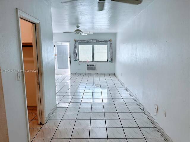 641 Espanola Way Unit 6, Miami Beach, FL 33139 - spare room featuring ceiling fan, a wall mounted air conditioner, and light tile patterned floors