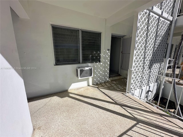 view of patio with an AC wall unit