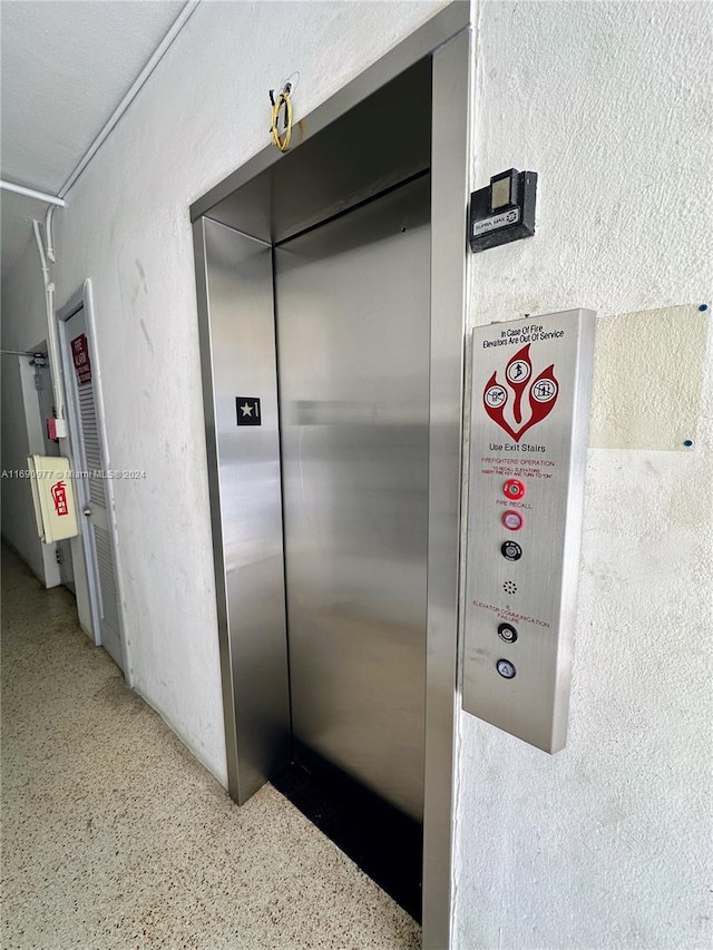 641 Espanola Way Unit 6, Miami Beach, FL 33139 - elevator featuring speckled floor and a textured wall