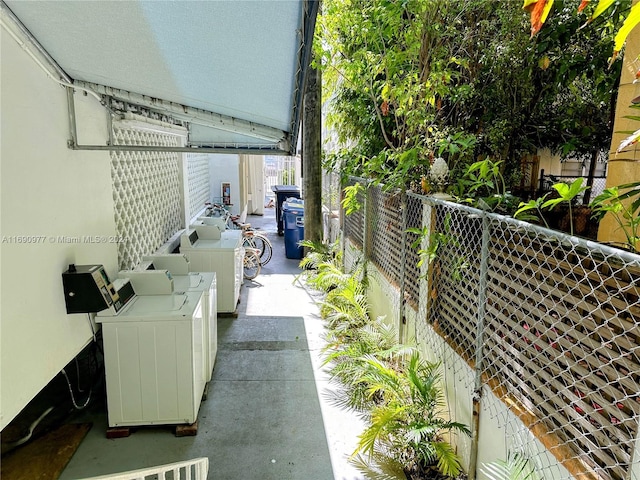 balcony with washer and clothes dryer and a patio