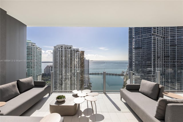 balcony featuring outdoor lounge area and a water view