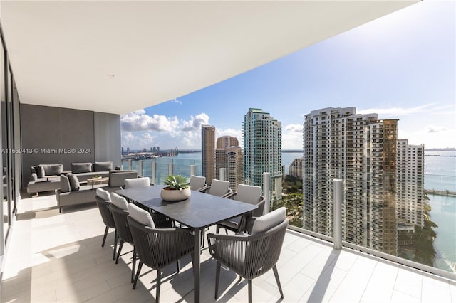 balcony featuring a water view and an outdoor hangout area