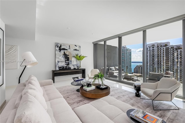 living room with a water view and a wall of windows