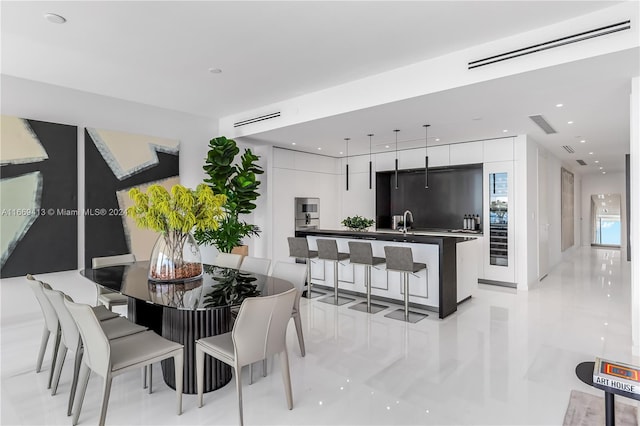 dining area featuring light tile patterned floors and sink