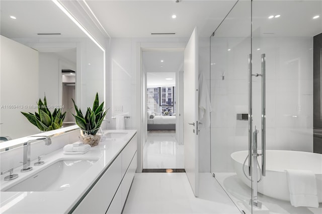 bathroom featuring a washtub, vanity, and tile patterned floors