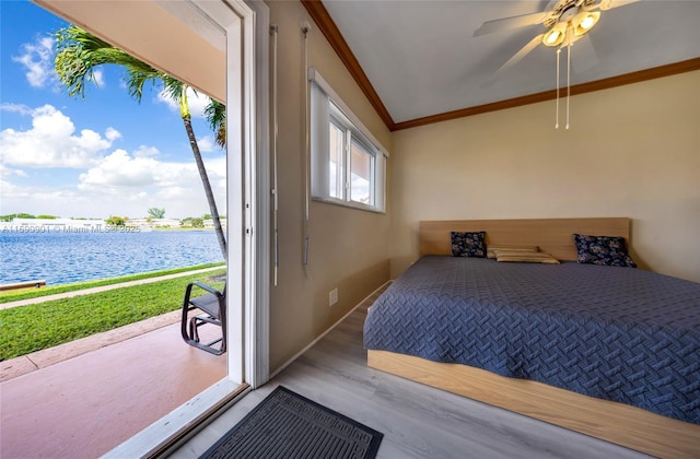 bedroom featuring crown molding, light wood-type flooring, ceiling fan, and a water view