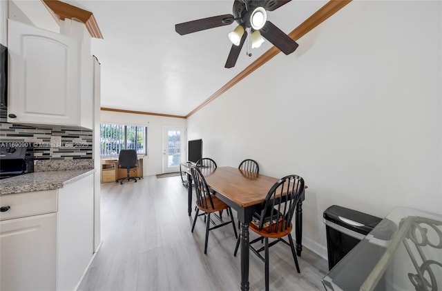 dining area featuring ceiling fan, lofted ceiling, ornamental molding, and light hardwood / wood-style floors