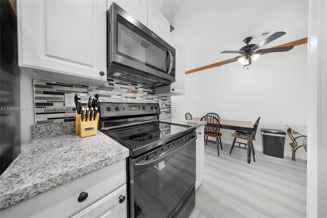 kitchen with white cabinetry, light stone counters, tasteful backsplash, black electric range, and light hardwood / wood-style flooring