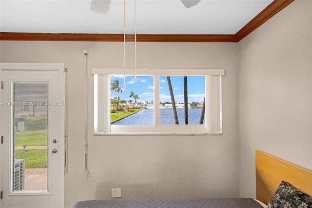 interior space with ornamental molding and a water view