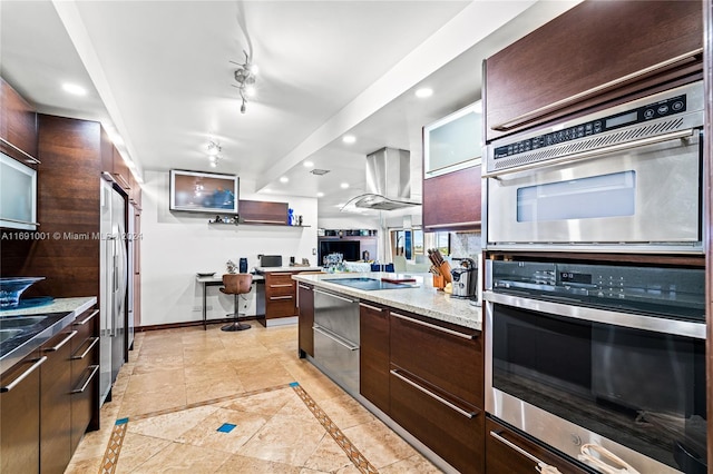 kitchen featuring dark brown cabinets, stainless steel appliances, light stone counters, and range hood