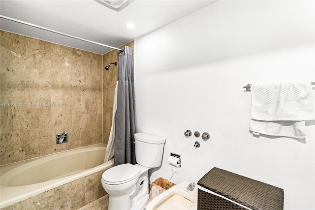 bathroom featuring shower / bath combo and toilet