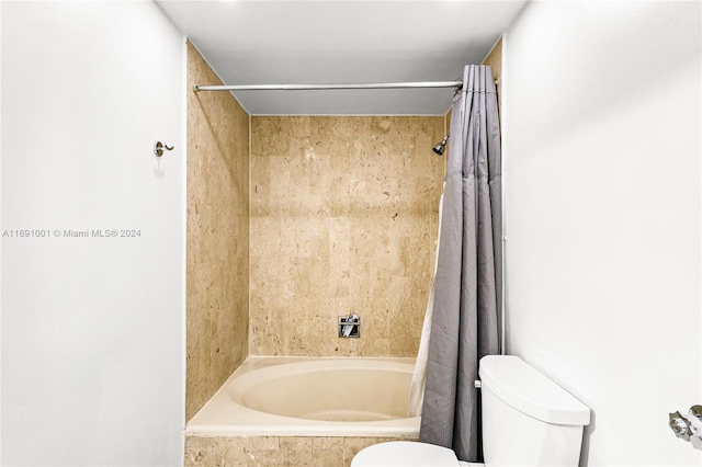 bathroom with toilet and shower / bathtub combination with curtain