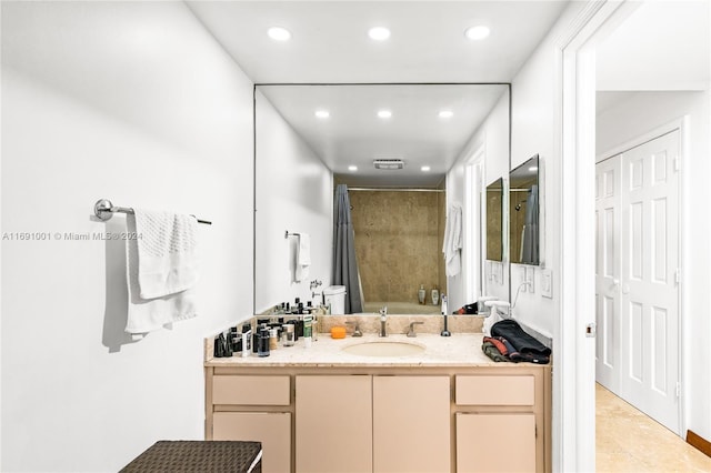 bathroom with tile patterned flooring, vanity, and bathtub / shower combination