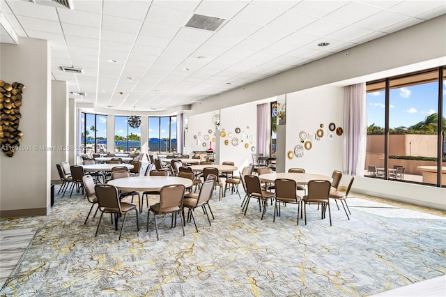 dining room with a drop ceiling