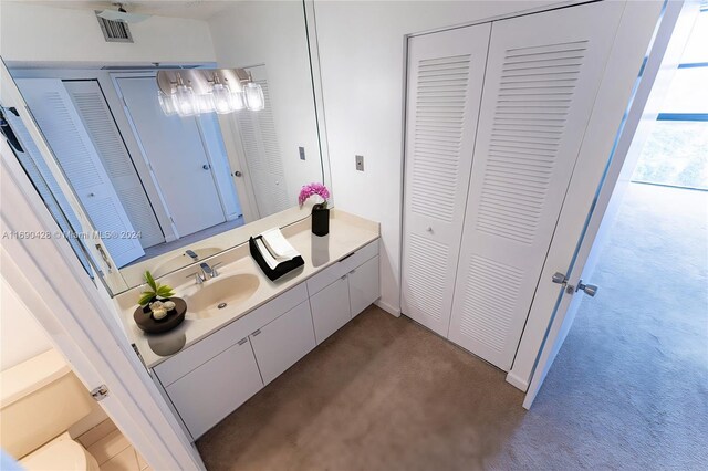 bathroom featuring vanity and toilet