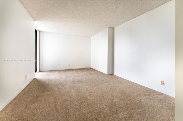 unfurnished room featuring a textured ceiling and carpet floors