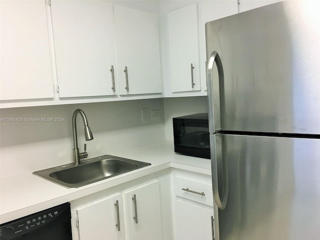 kitchen featuring white cabinetry, sink, and black appliances