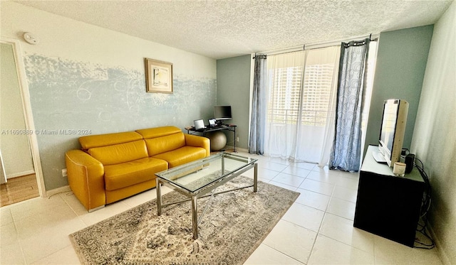 tiled living room featuring a textured ceiling