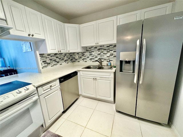 kitchen with tasteful backsplash, light tile patterned flooring, stainless steel appliances, white cabinetry, and sink