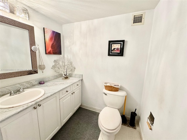 bathroom with toilet and vanity