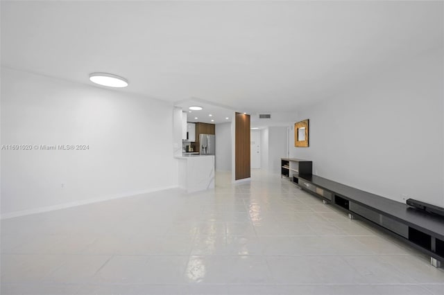 unfurnished living room with light tile patterned floors