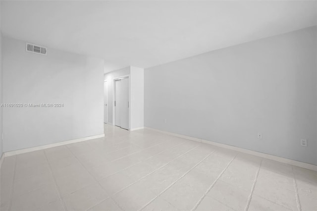 unfurnished room with light tile patterned flooring