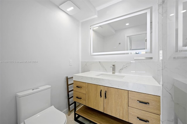 bathroom featuring toilet and vanity