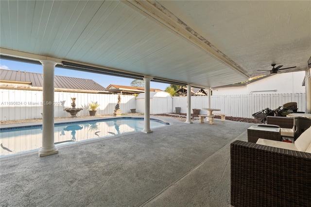 view of swimming pool featuring ceiling fan and a patio area