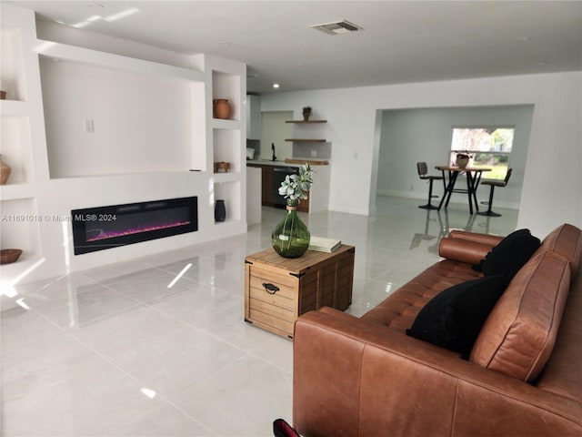 living room featuring built in features and light tile patterned floors