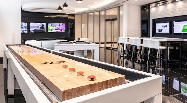 recreation room with dark tile patterned flooring